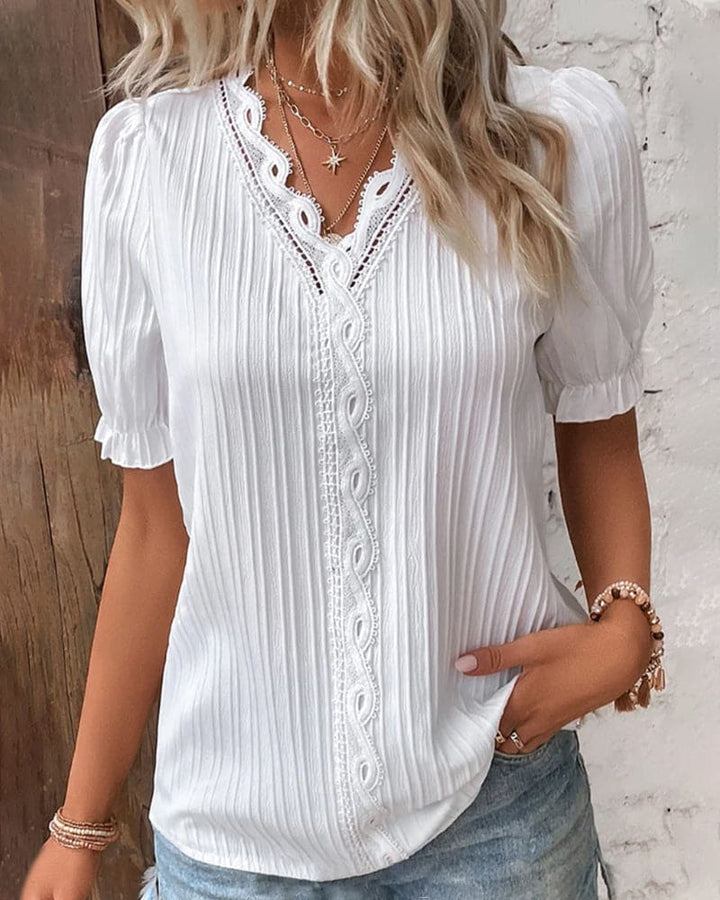 Camicetta elegante in pizzo con scollo a V
