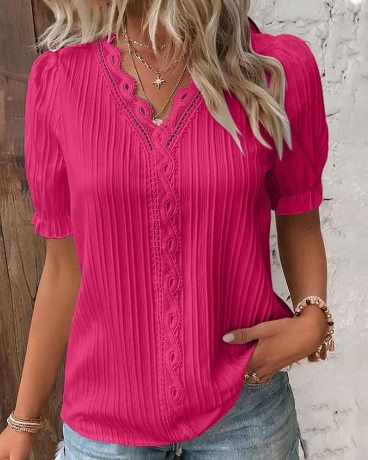 Camicetta elegante in pizzo con scollo a V