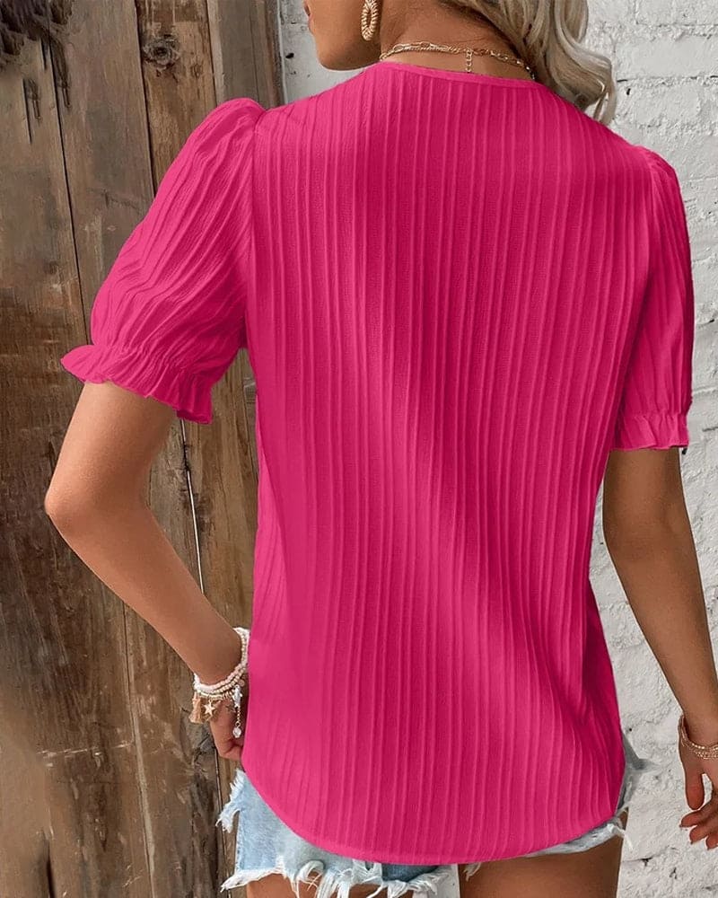 Camicetta elegante in pizzo con scollo a V